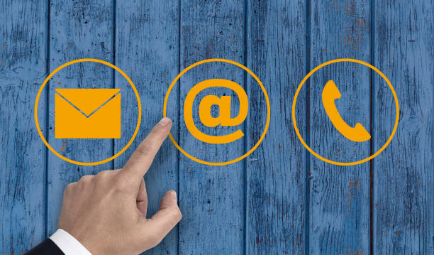 istock Hand pointing at contact options icons e-mail letter telephone 810753548