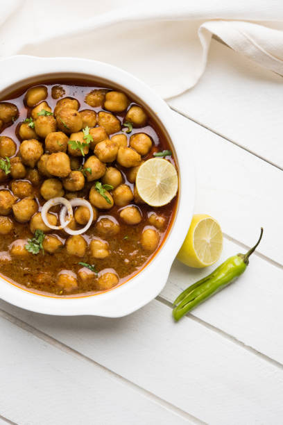 istock Chickpeas Masala - Chole masala curry ,traditional north indian lunch, dinner menu served in a ceramic bowl, selective focus 810756394