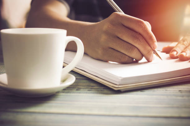 istock hand of people, student writing and note on notebook on wood table with copy space, in library, concept as education attempt and make effort to win, intend to improve knowledge for future life 810772272
