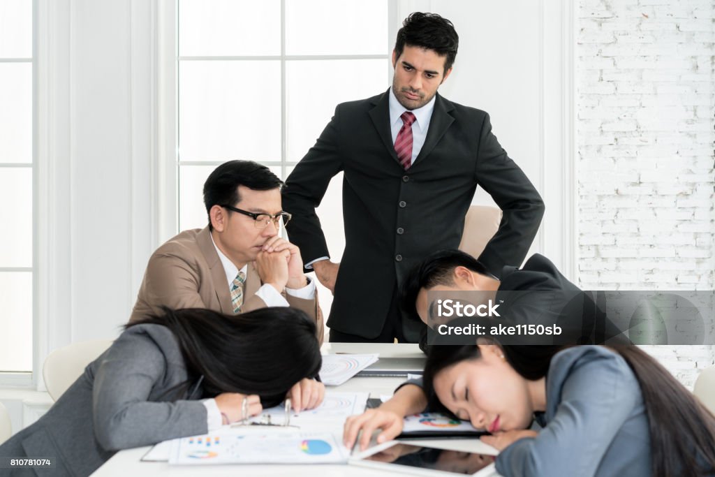 Boss angry when business people team sleeping on meeting room in office. Business people team tired after working hard. Boredom Stock Photo