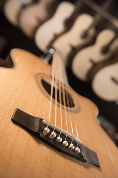Many Classical Guitars Hanging on Wall in the Shop