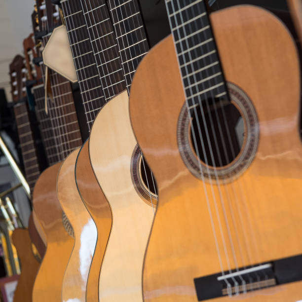 istock Many Classical Guitars Hanging on Wall in the Shop 810782306