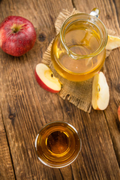 istock Apple Cider (selective focus) on vintage wooden background 810794646