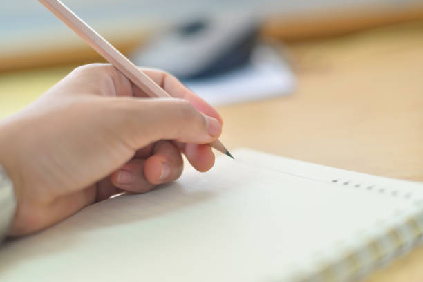 istock Blurred hand writing on notebook in clear tone. 810795234