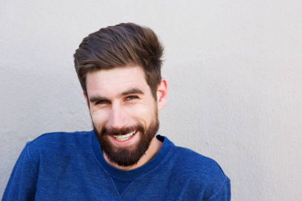 istock Close up handsome man smiling against gray wall 810797742