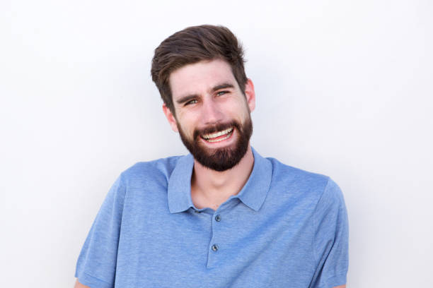 istock Close up smiling confident man with beard by white background 810797802