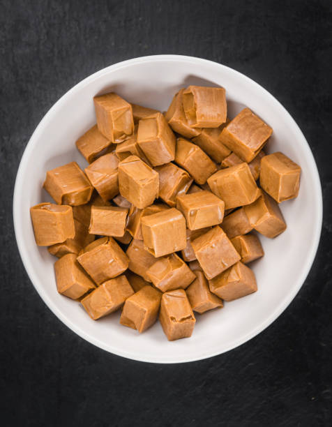 istock Portion of Caramel pieces on a slate slab 810798500