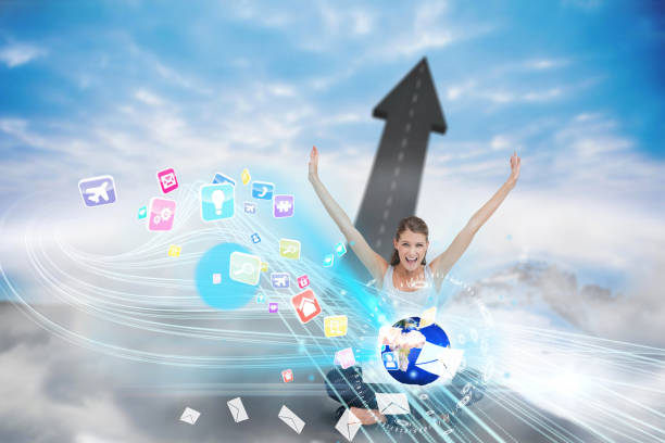 istock Cheering blonde using laptop with app icons 810798558