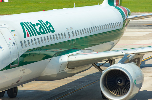 Plane of Alitalia, taxiing before take off in Naples airport in Italy