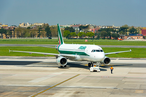 Plane of Alitalia, taxiing before take off in Naples airport in Italy