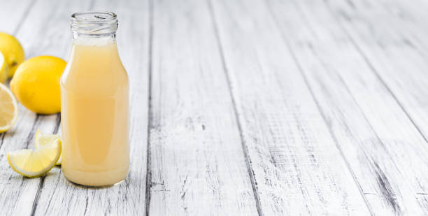 istock Wooden table with Lemon Juice (selective focus) 810824208