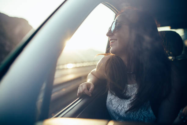 istock Young female looking out of a car window 810832046
