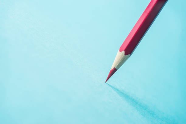 istock ne yellow color pencil stand on blue paper background 810840368
