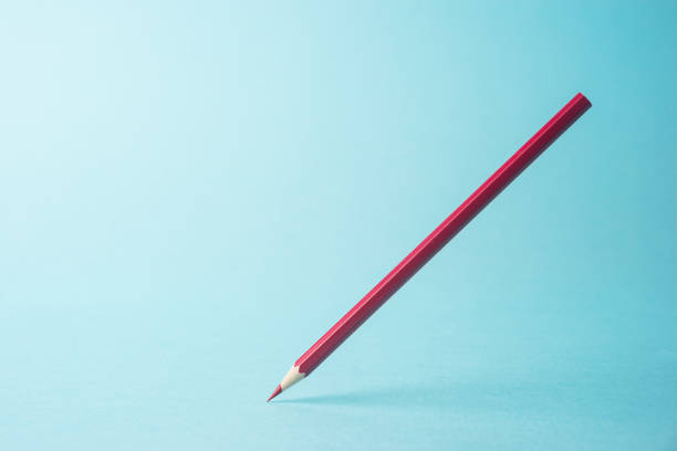 istock ne yellow color pencil stand on blue paper background 810840610