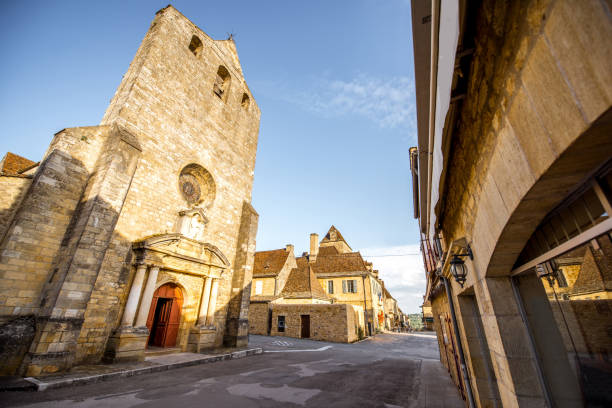 Sunset view on the old church and town hall in Domme village in France