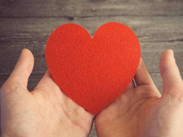 istock a big red heart in his hand. toned 810846990