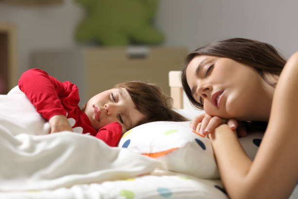 istock Mother and toddler sleeping in a bed 810847214