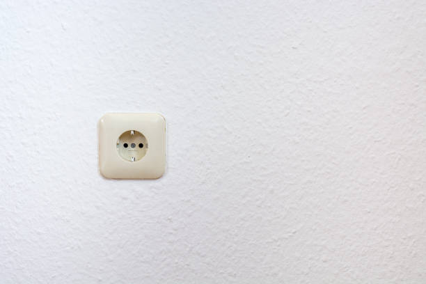 istock One single european plug on a white wall from the front 810847672
