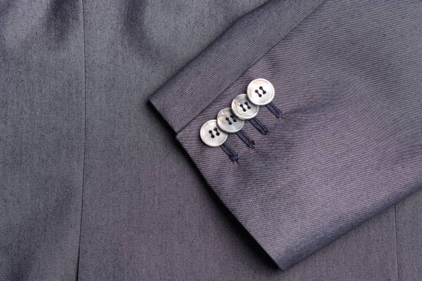 istock Four buttons on a grey business jacket sleeve close up 810850212