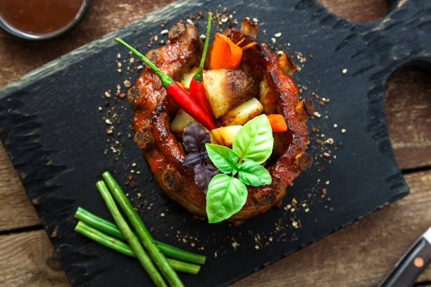 istock Barbecue pork ribs on wooden board, top view 810851042