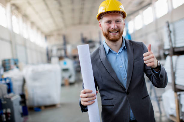 istock Young satisfied manager wearing yellow helmet 810859614