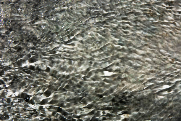 istock Beautiful water flow on the rock background 810864530