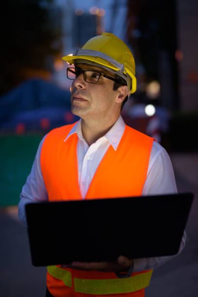 istock Portrait of handsome Persian man construction worker on the construction site at night 810869480