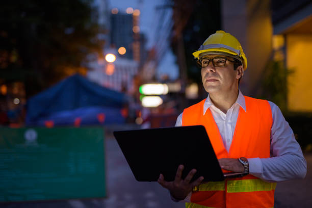 istock Portrait of handsome Persian man construction worker on the construction site at night 810869482