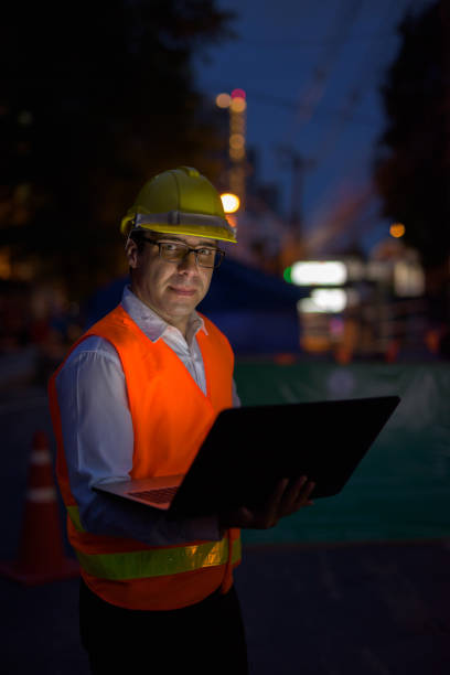 istock Portrait of handsome Persian man construction worker on the construction site at night 810869560