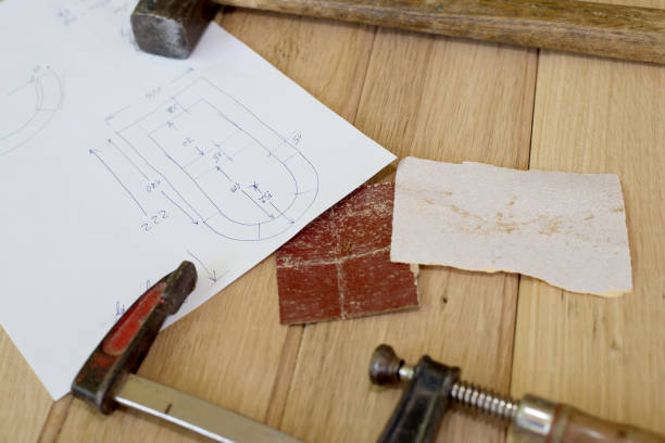 istock Sketch, hammer and tighten on a table. Carpentry workshop. 810874440