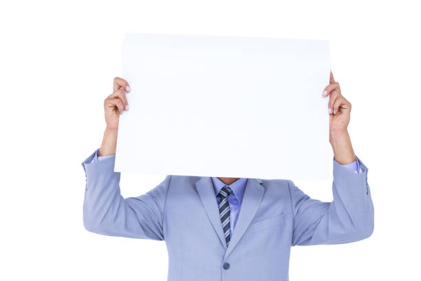 istock Portrait of a businessman hiding his face behind a blank panel 810876848