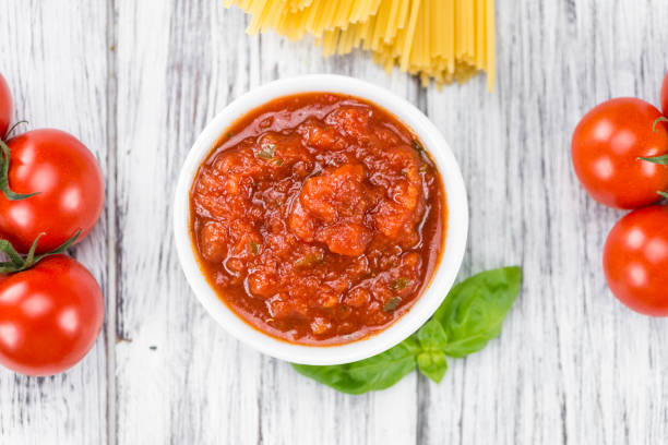 istock Tomato Sauce (selective focus) on vintage wooden background 810877000