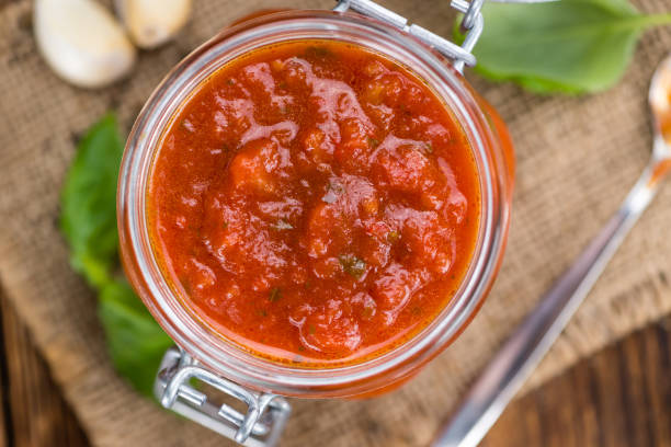 istock Wooden table with Tomato Sauce (selective focus) 810877356
