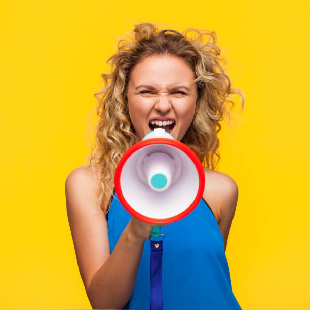 istock Woman yelling with loudspeaker 810877380