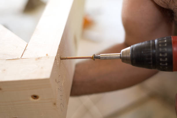 istock Screwing screw with screwdriver. Selected focus. 810877622