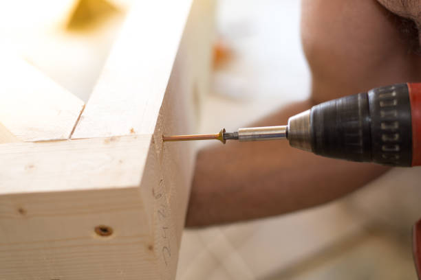 istock Screwing screw with screwdriver. Selected focus. 810882720