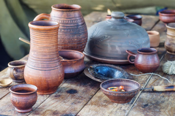 istock Dishes and objects of medieval life on a wooden table 810883776