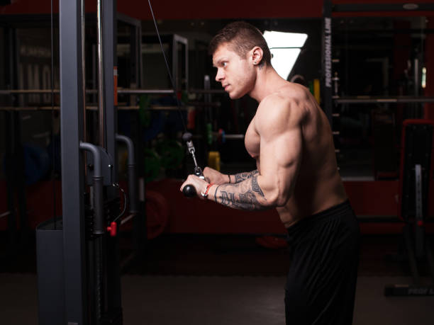 istock bodybuilder man performing workout at the gym 810886560