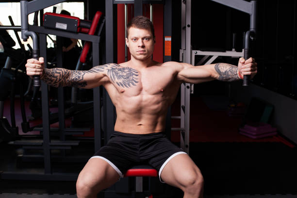 istock bodybuilder man performing workout at the gym 810889066