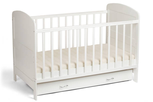 istock White wooden baby crib 810905614
