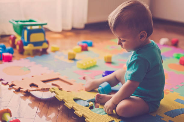 istock Cute boy playing with toys 810915558