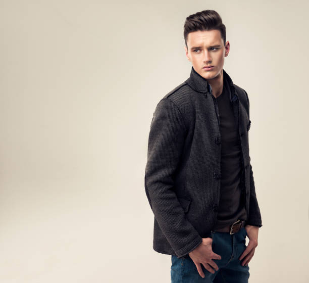 Portrait of a handsome young man with trendy hairstyle, dressed in a stylish and fashionable wool jacket.