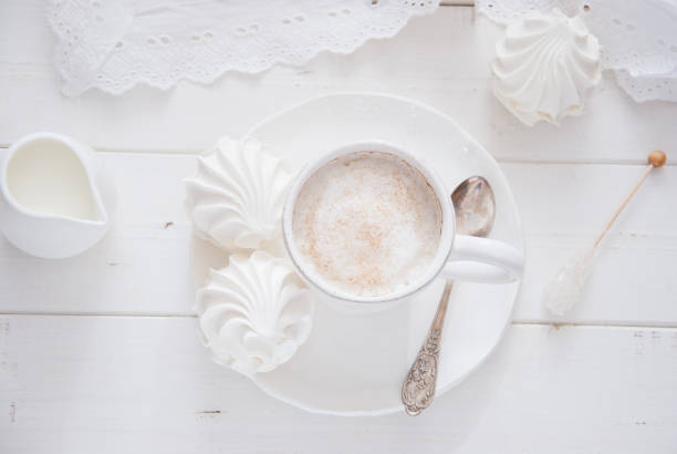 istock Coffee and marshmallow on a white wooden background 810918976