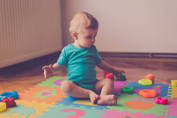 istock Adorable baby boy playing with toys 810919018