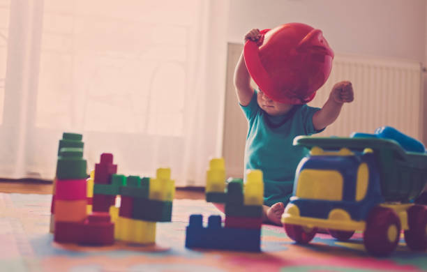 istock Baby playing with colorful plastic blocks 810919324