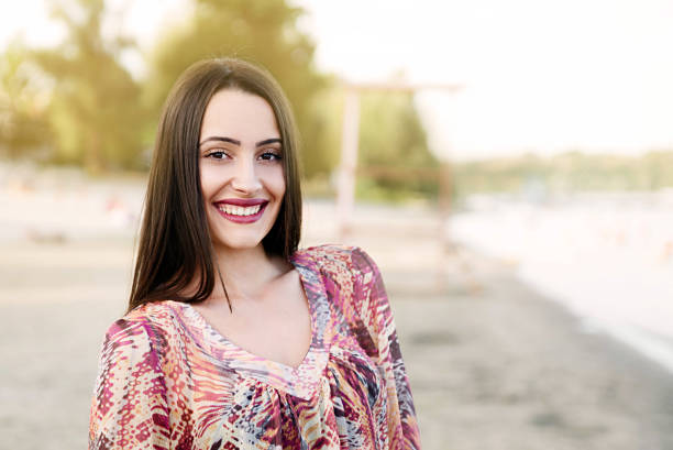 Portrait on smiling young woman on beach