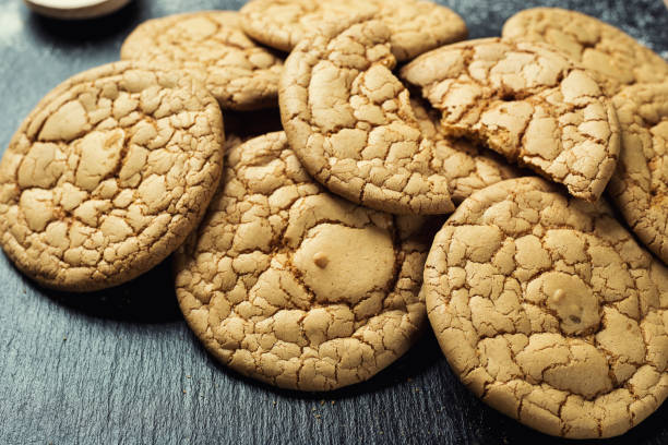 istock Biscuit sweet cookie background. Domestic stacked butter biscuit pattern concept,close up macro.Homemade cookies on wooden table.Cereal biscuits with the sesame,peanuts,sunflower and amaranth. 810942818