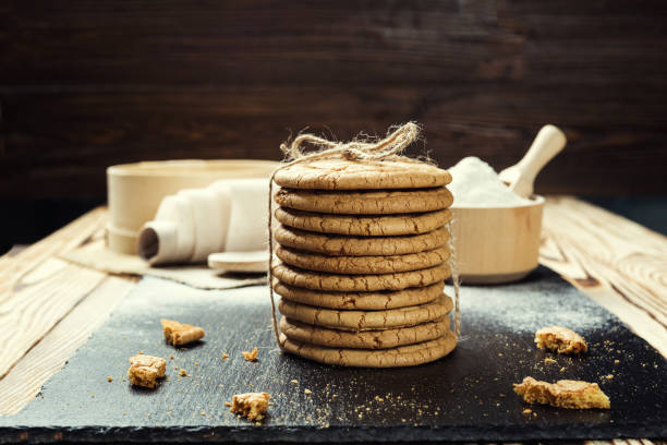 istock Biscuit sweet cookie background. Domestic stacked butter biscuit pattern concept,close up macro.Homemade cookies on wooden table.Cereal biscuits with the sesame,peanuts,sunflower and amaranth. 810942894