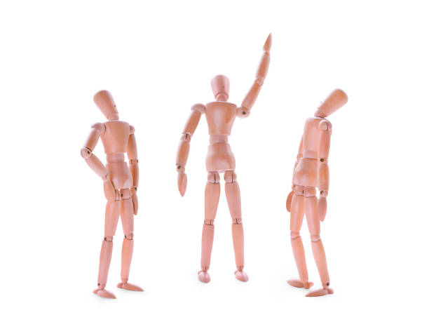 istock Wooden dummies one showing and two looking up. Isolated on white 810974564