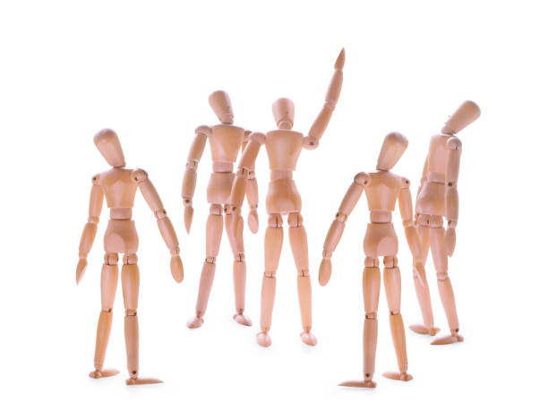 istock Wooden dummies one showing and some looking up. 810974632